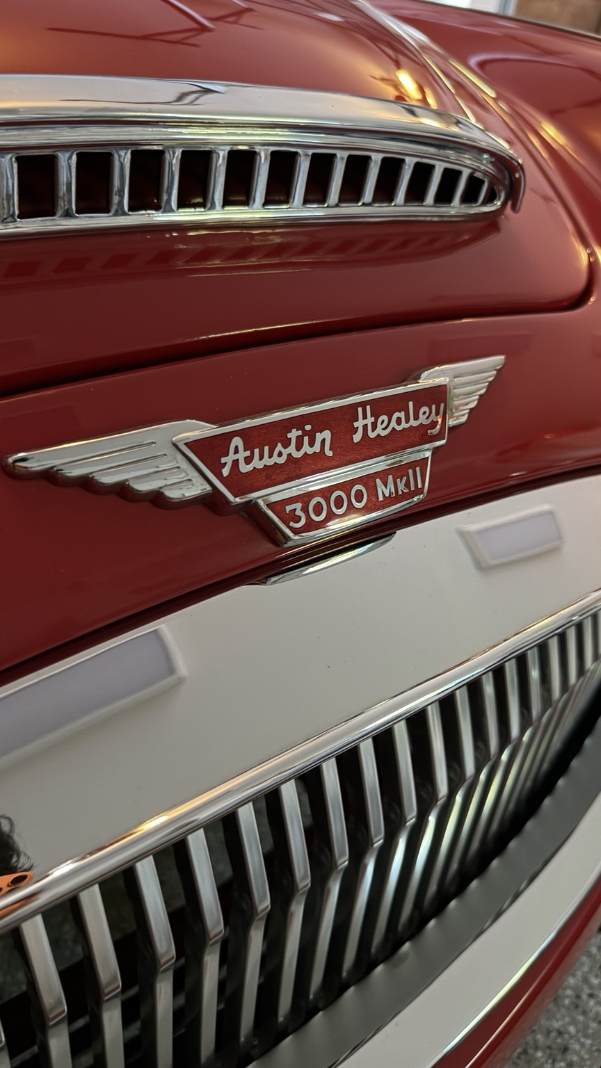 Close-up of vintage Austin Healey 3000 MkII badge and chrome grille