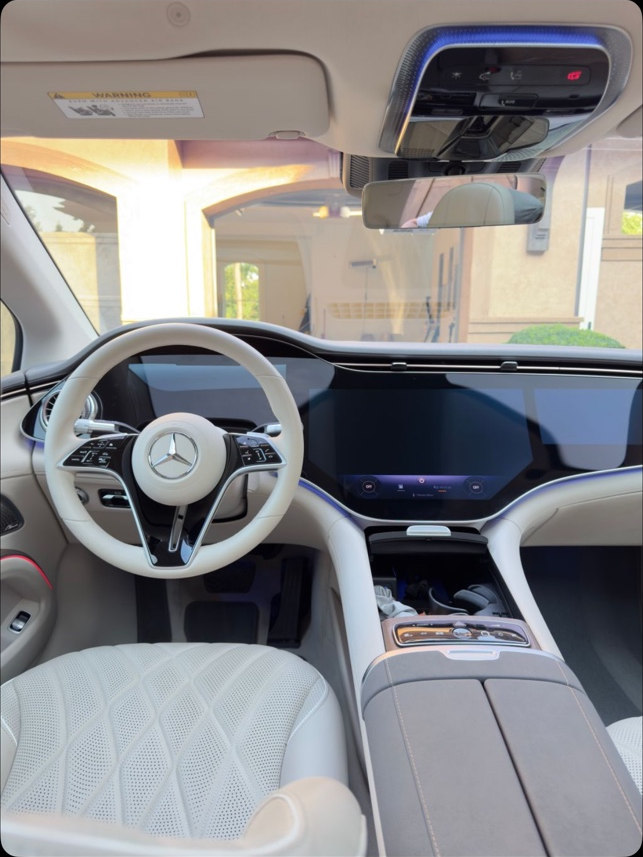 Clean light-colored Mercedes front seats, dashboard and steering wheel