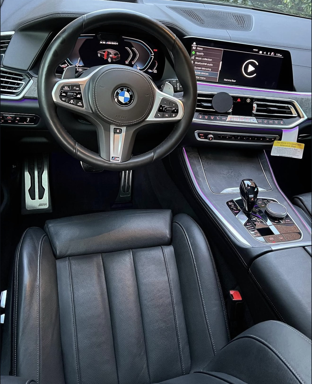 Detailed black BMW cabin with leather seats, dashboard and center console
